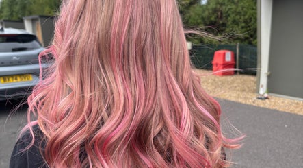 Pink wavy hairstyle from Luna Hair, Redditch, England, GB. Vibrant color and styling showcase expert technique.