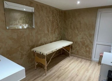 Calming therapy room at Sd Aesthetics and Beauty, Norwich, England, GB, featuring a massage table and mirror.