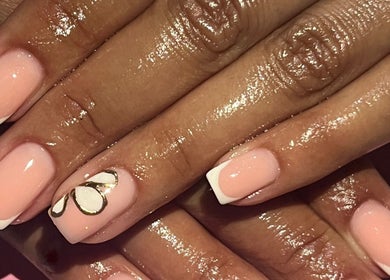 Elegant French manicure with floral art at Nailed_itby_k in Worcester, Western Cape, ZA.