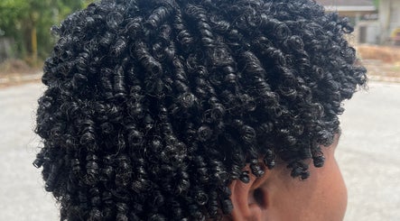 Close-up of styled curly hair at Melena Hair Studio, Willemstad, Curaçao, CW showcasing intricate curls.