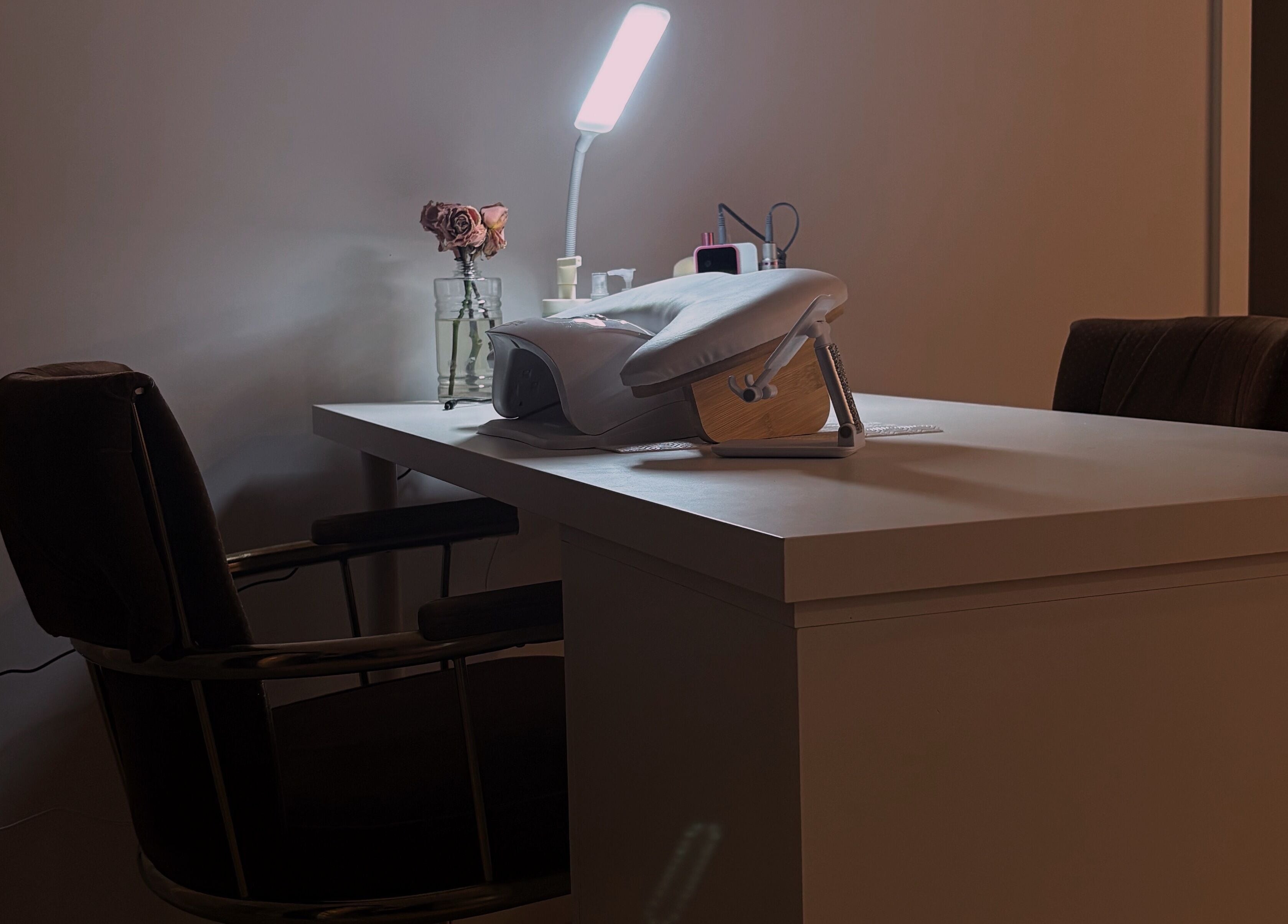 Elegant manicure setup at POLISHED ☆, Steinbach, Manitoba, CA featuring cozy chair and lamp.