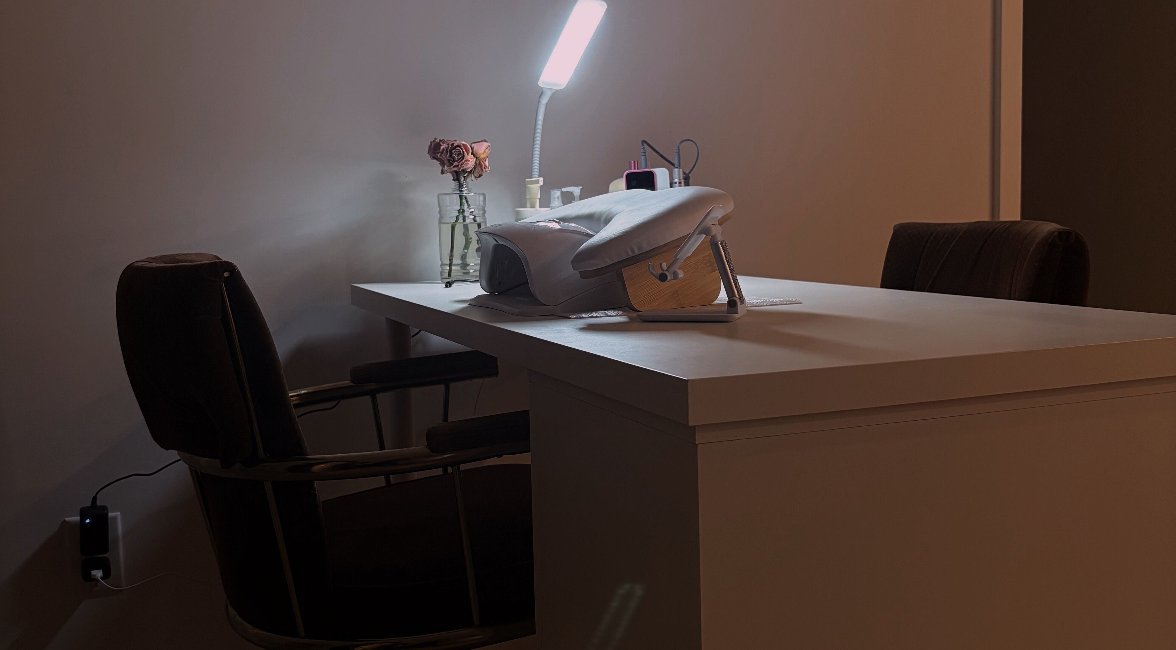 Elegant manicure setup at POLISHED ☆, Steinbach, Manitoba, CA featuring cozy chair and lamp.