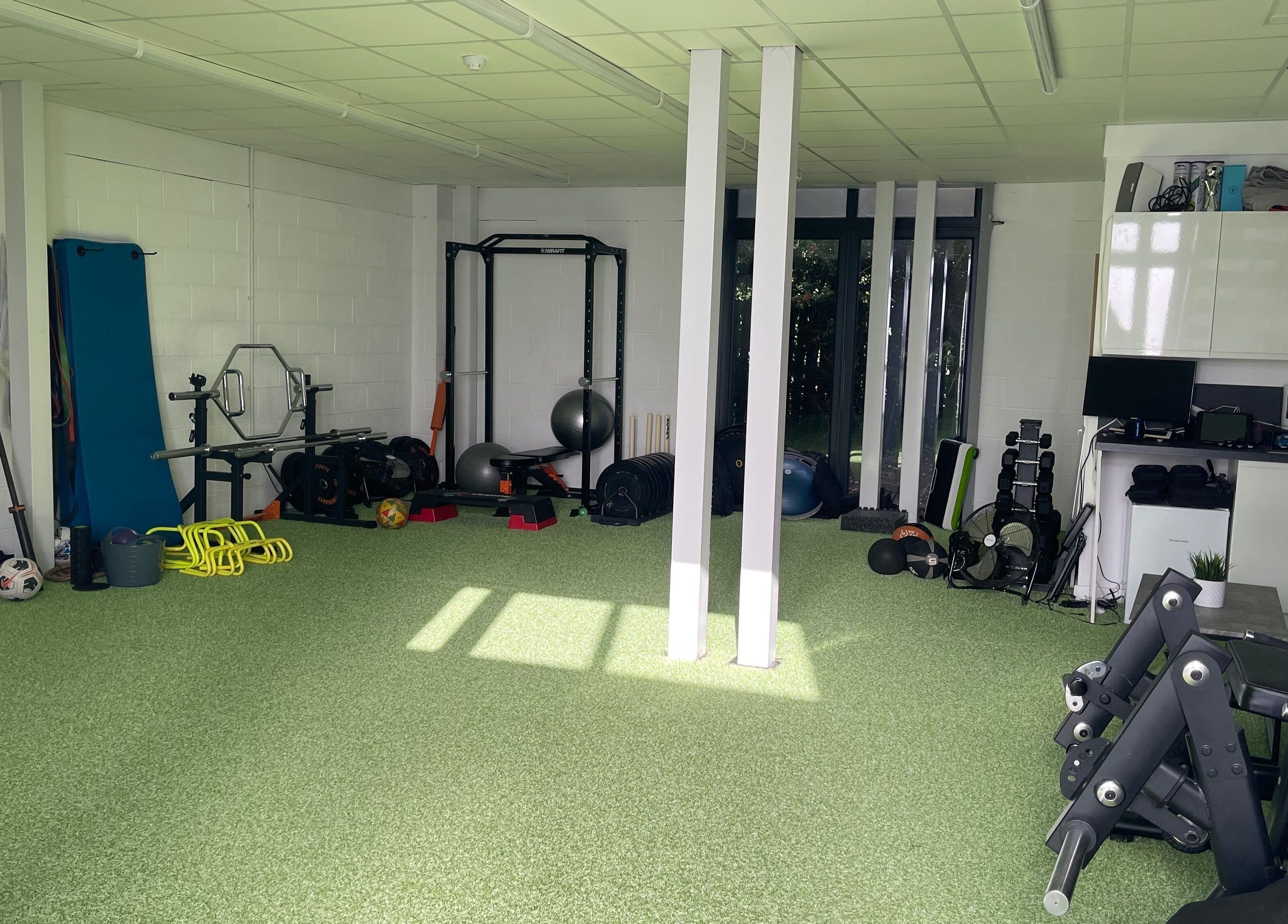 Spacious fitness area at True Form Therapy Ltd in Three Legged Cross, England, GB, featuring various exercise equipment.
