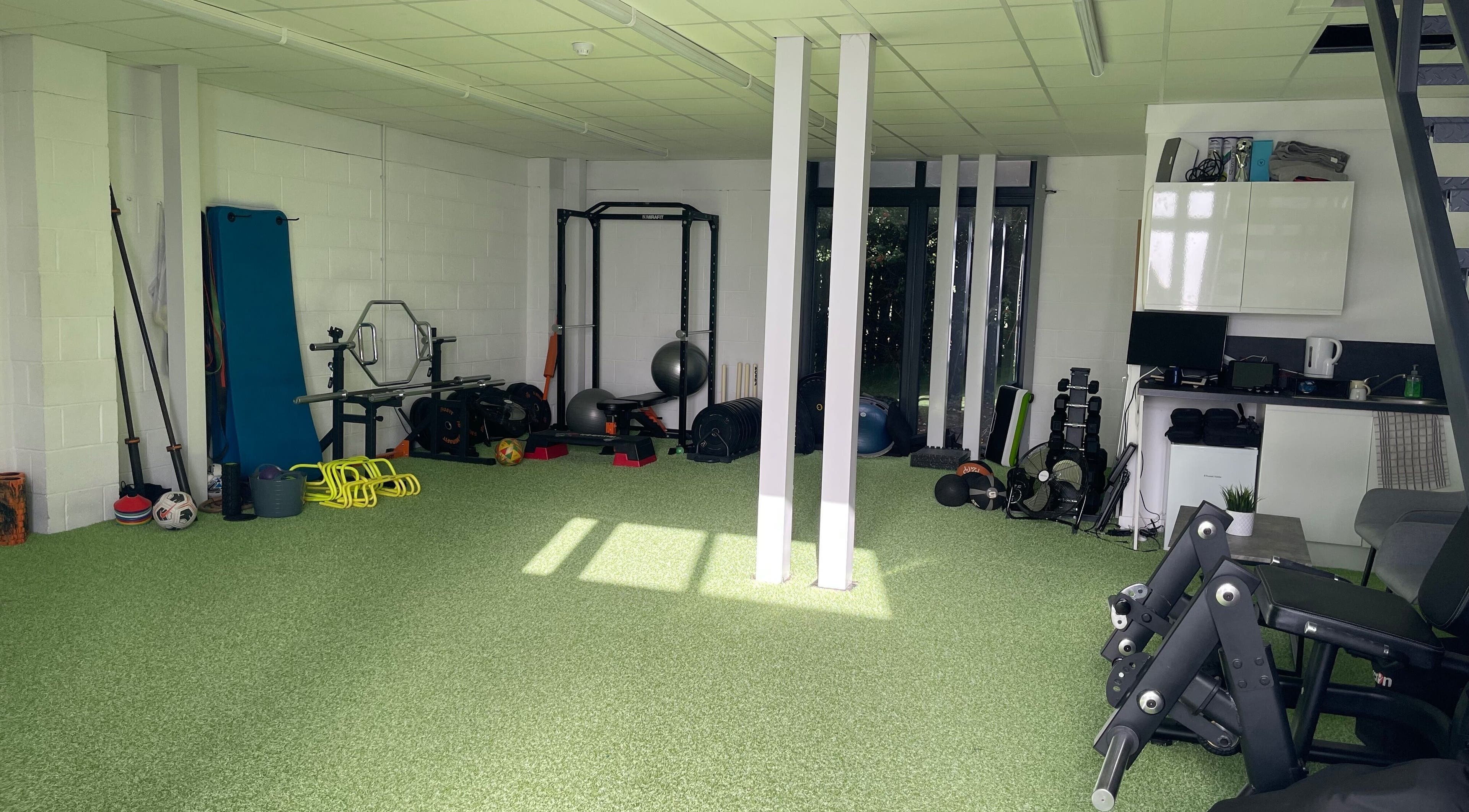 Spacious fitness area at True Form Therapy Ltd in Three Legged Cross, England, GB, featuring various exercise equipment.