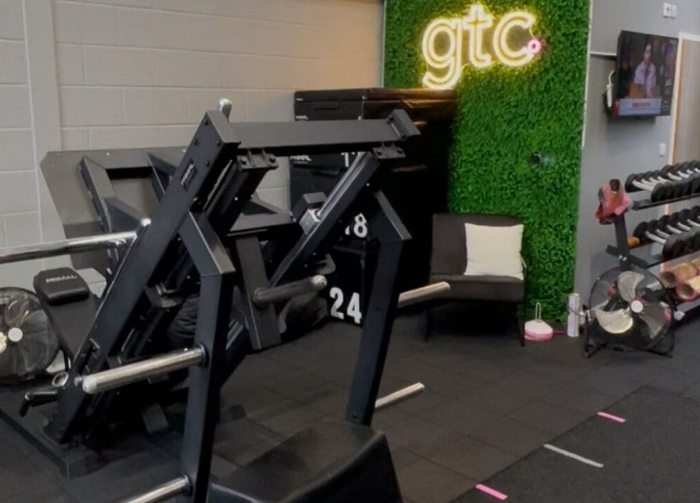 Modern fitness area at True Form Therapy Ltd, Three Legged Cross, England, GB featuring gym equipment and seating.