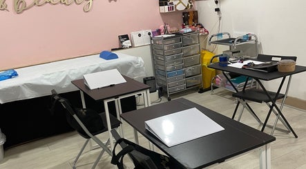 Training room at IA Brows and Beauty, London, England, GB showcasing neatly arranged desks and tools.