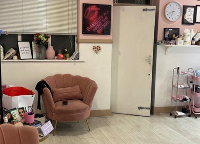 Stylish seating area at IA Brows and Beauty in London, England, GB with cozy chairs and decor.