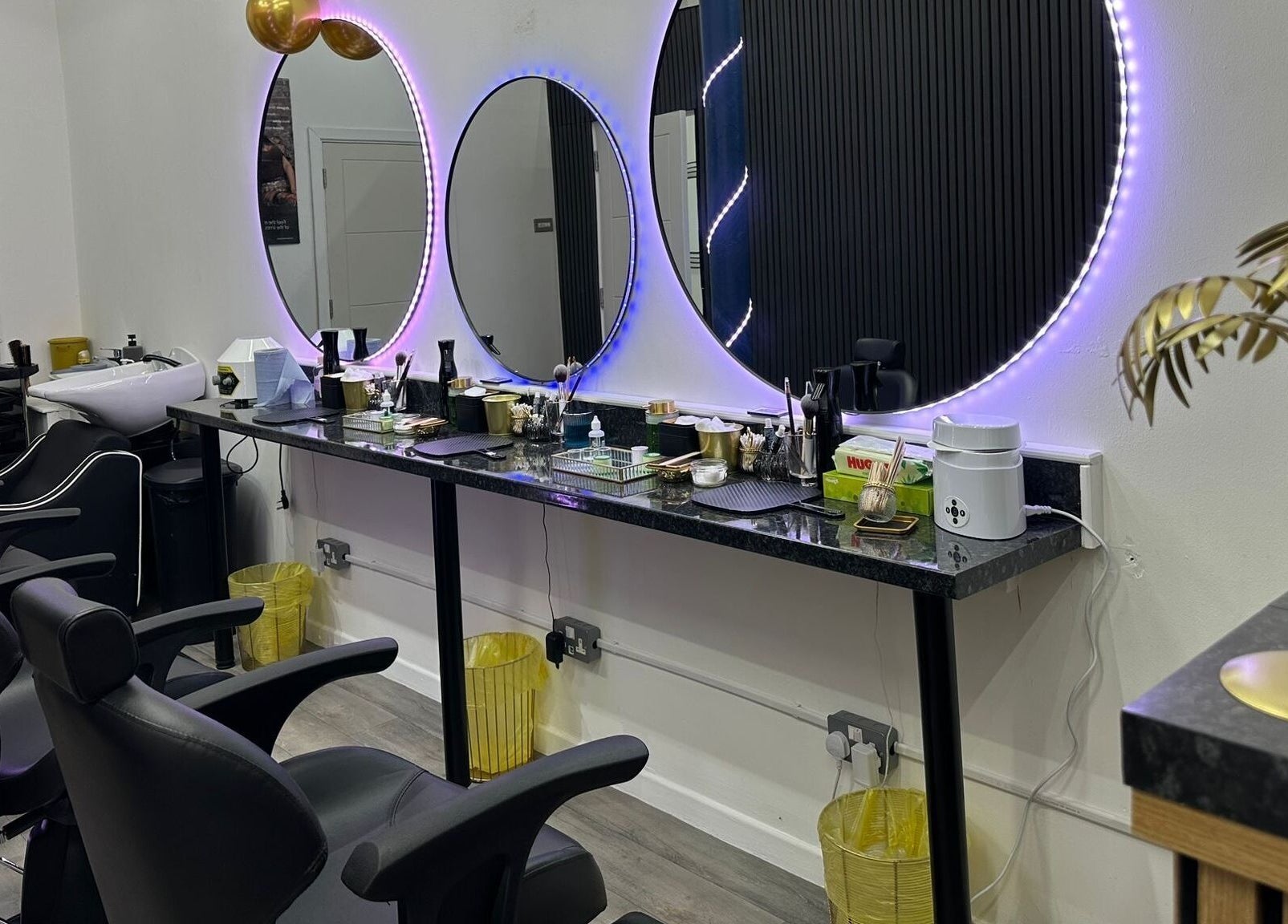 Elegant salon with illuminated mirrors at MKM Beauty and Aesthetics, Belfast, Northern Ireland, GB.