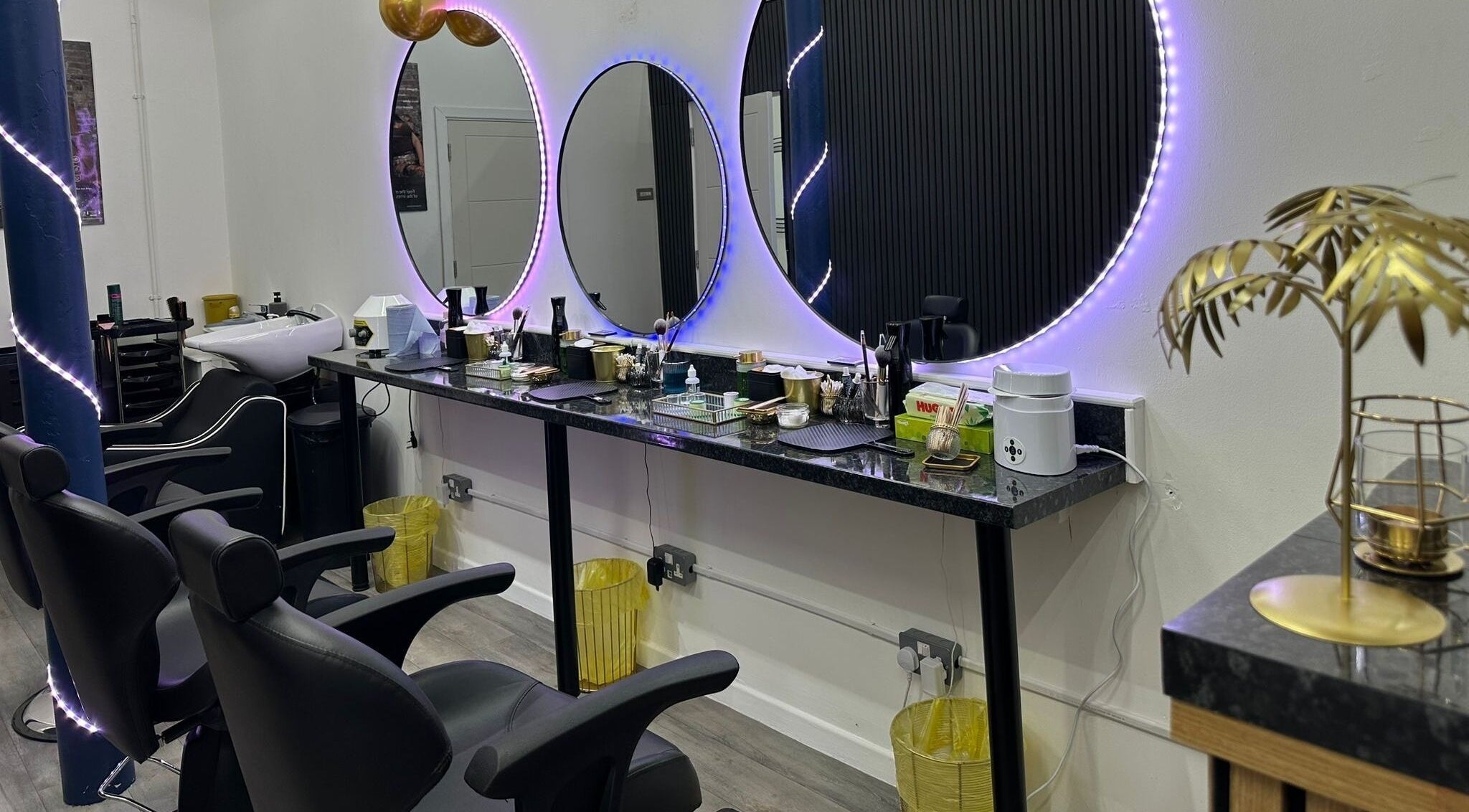 Elegant salon with illuminated mirrors at MKM Beauty and Aesthetics, Belfast, Northern Ireland, GB.