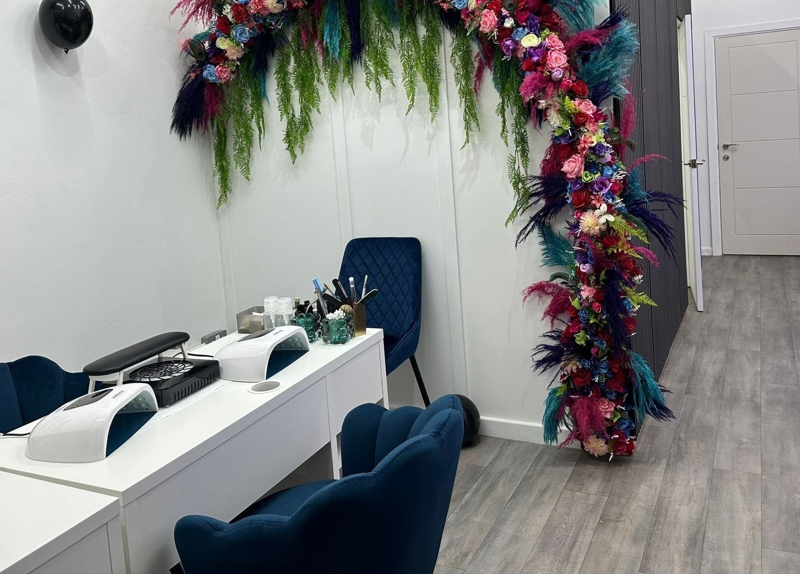 MKM Beauty and Aesthetics in Belfast, Northern Ireland, GB, features a floral décor in a chic salon setting.