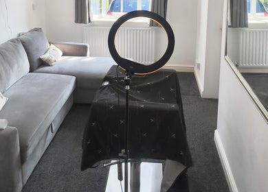 Cozy beauty room in Priestycuts, Barnstaple, England, GB featuring a massage table and ring light.