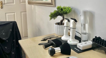 Barber tools and decor at Priestycuts, Barnstaple, England, GB, showcasing a stylish workstation.