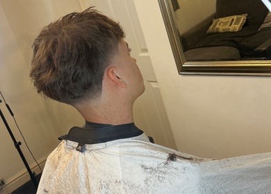 A stylish haircut reflected in a mirror at Priestycuts, Barnstaple, England, GB.