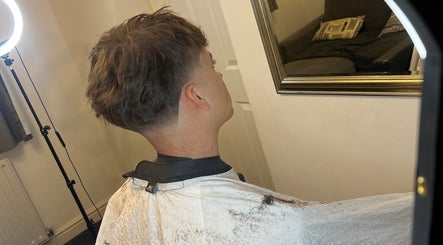 A stylish haircut reflected in a mirror at Priestycuts, Barnstaple, England, GB.