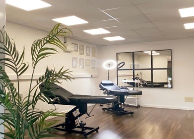Relaxing treatment room at Hydro Clinic, Liverpool, England, GB with modern chairs and lush plants.