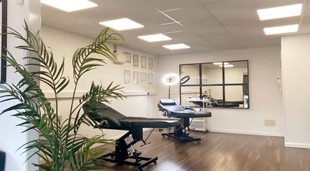 Relaxing treatment room at Hydro Clinic, Liverpool, England, GB with modern chairs and lush plants.