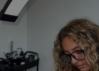 Beauty professional focused at work in Vanillalash, Sint Maarten, SX, showcasing tools and equipment.