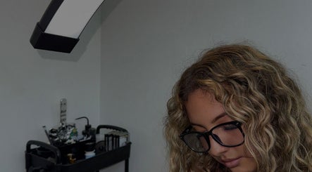 Beauty professional focused at work in Vanillalash, Sint Maarten, SX, showcasing tools and equipment.