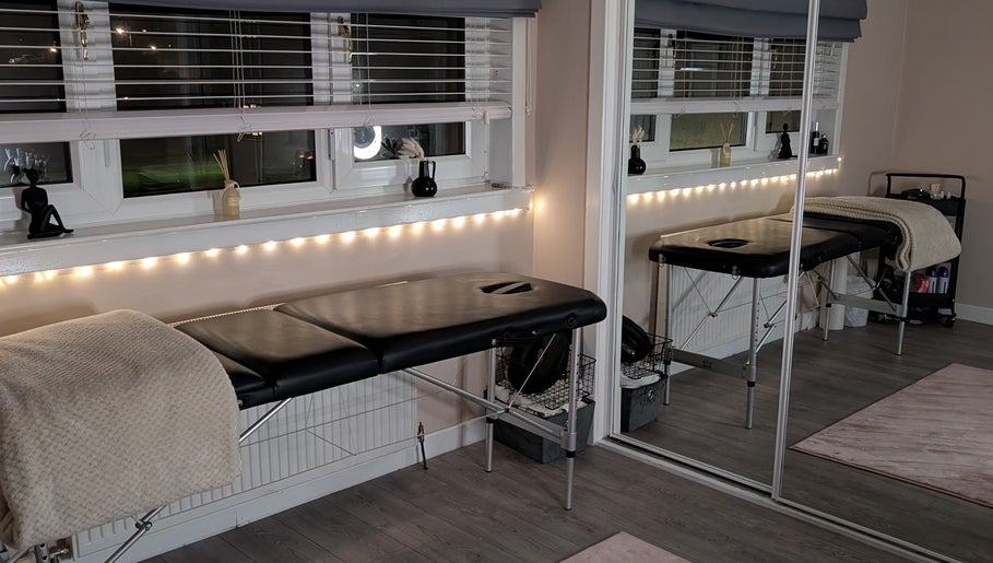 Tranquil massage room at Shbeautyfife, Cowdenbeath, Scotland, GB with a cozy massage bed and soft lighting.
