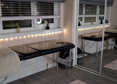 Tranquil massage room at Shbeautyfife, Cowdenbeath, Scotland, GB with a cozy massage bed and soft lighting.