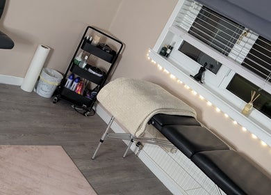 Cozy treatment room at Shbeautyfife, Cowdenbeath, Scotland with massage table and ambient lighting.