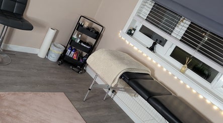 Cozy treatment room at Shbeautyfife, Cowdenbeath, Scotland with massage table and ambient lighting.