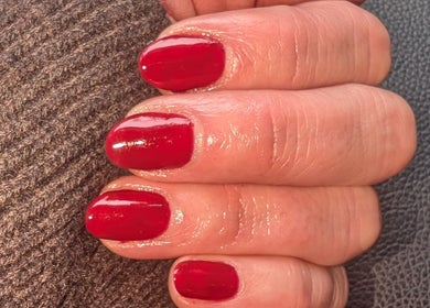 Close-up of well-manicured red nails at Shbeautyfife, Cowdenbeath, Scotland, GB.