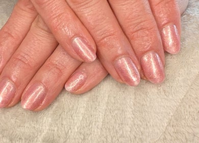 Shiny manicured nails at Shbeautyfife, Cowdenbeath, Scotland, GB on a soft beige background.