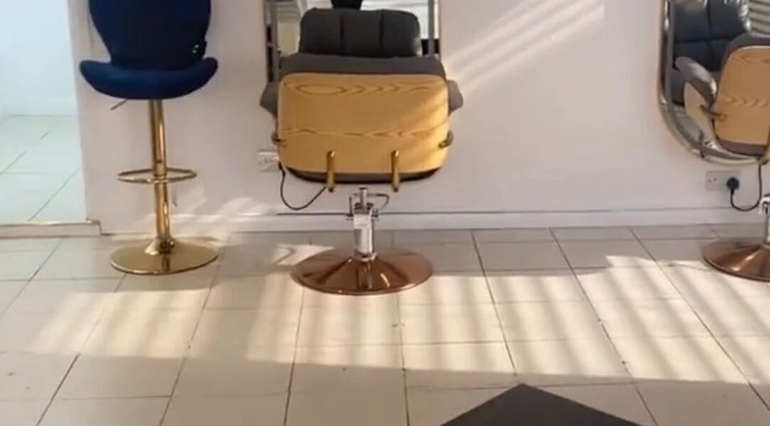 Luxurious salon chair and mirror at Eunajem Studios, London, England, GB, showcasing modern elegance.