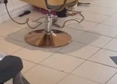 Stylish salon chair at Eunajem Studios, London, England, GB, offering a luxurious beauty experience.