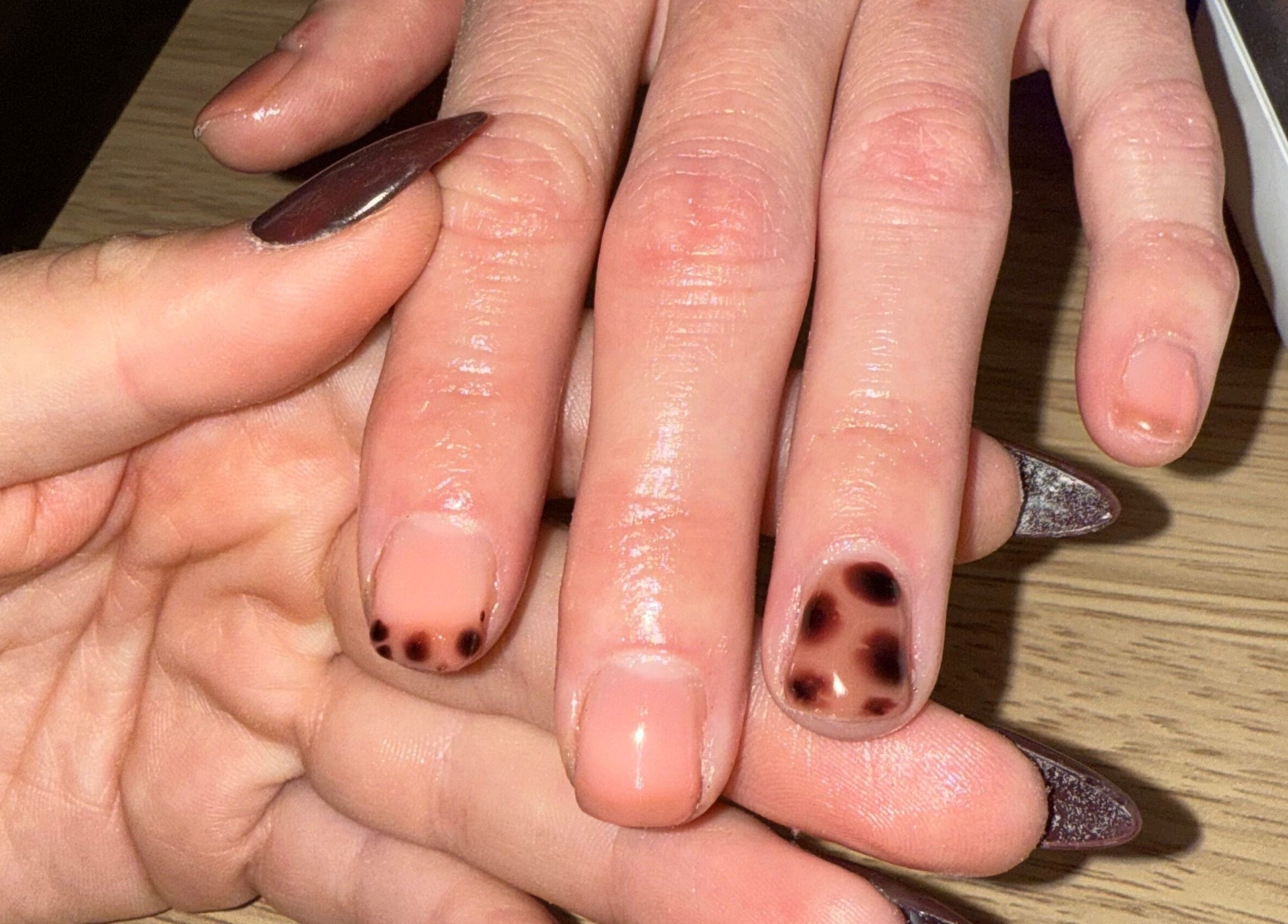 Stylish nail art at The Glow Lab, Corringham, England, GB. Close-up of unique nail design and care.