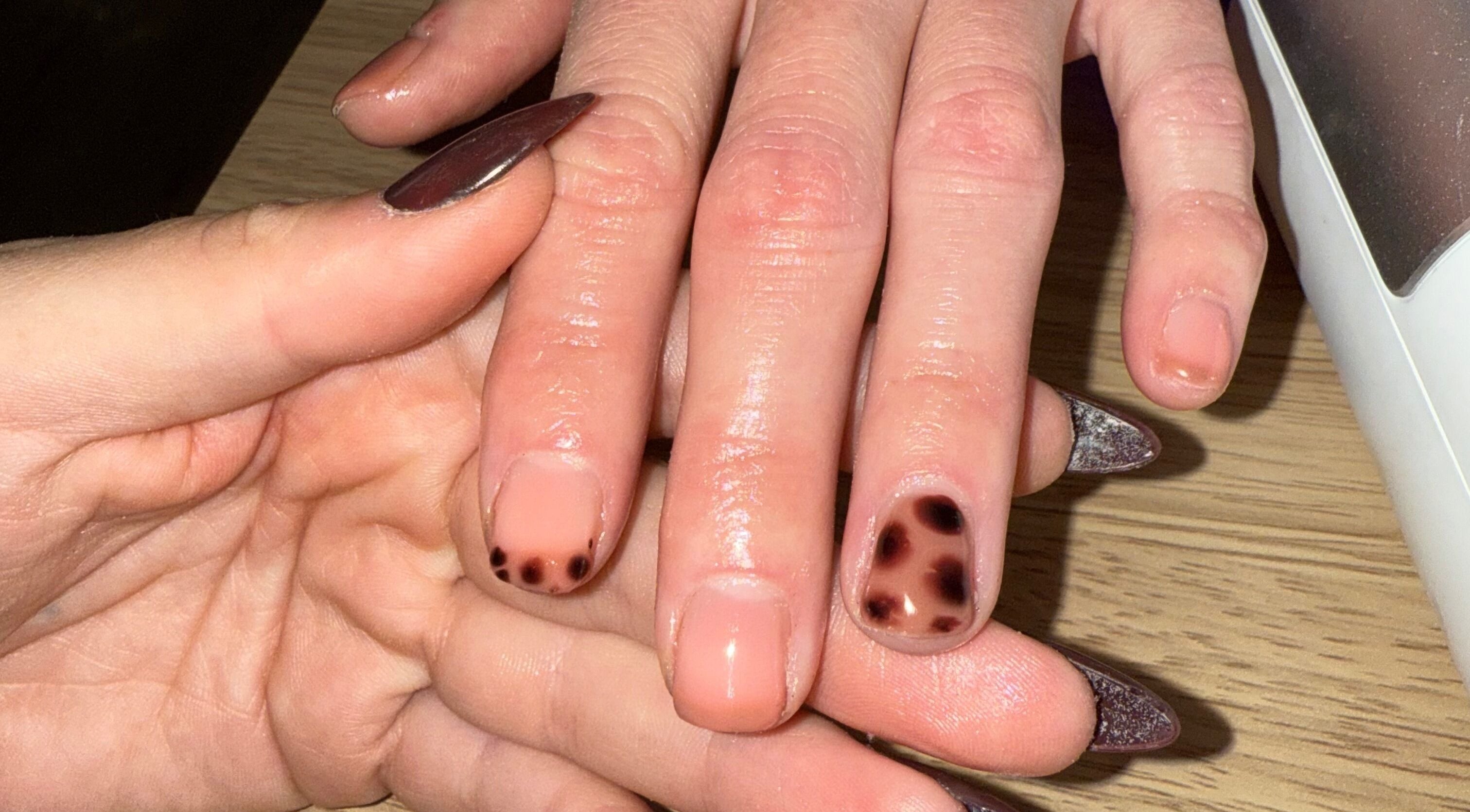 Stylish nail art at The Glow Lab, Corringham, England, GB. Close-up of unique nail design and care.