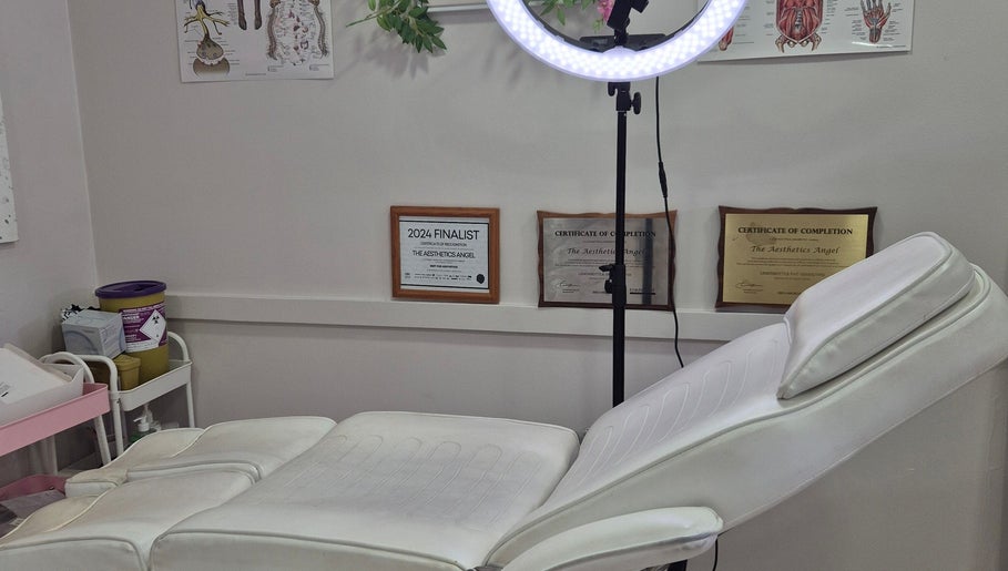 Cozy Ipswich treatment room in Ipswich, England, GB with white recliner and certificates on display.