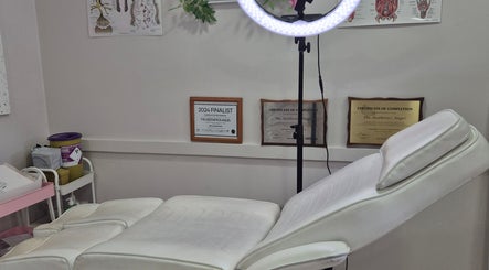 Cozy Ipswich treatment room in Ipswich, England, GB with white recliner and certificates on display.