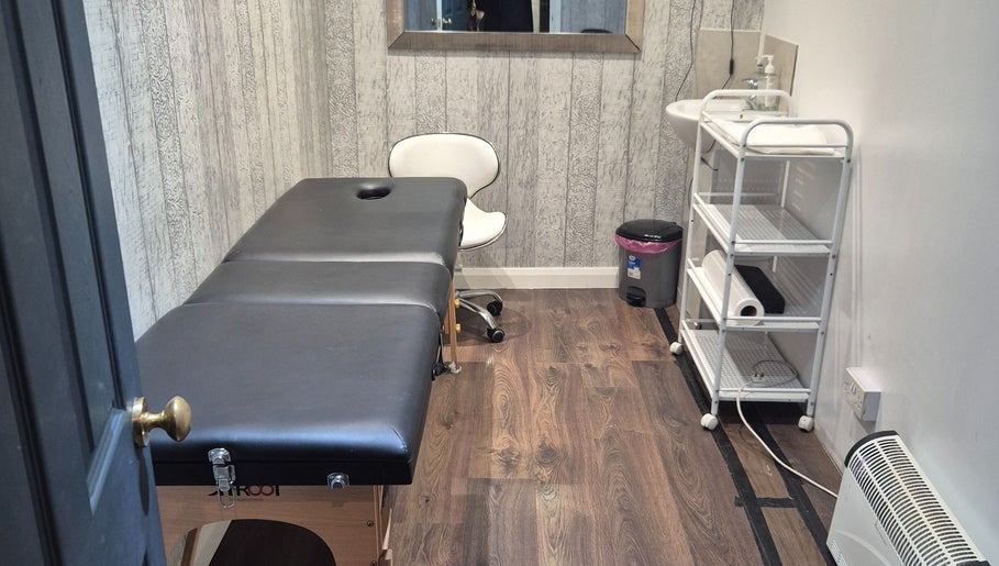 Tranquil treatment room at The Aesthetics Angel, London, England, GB, featuring a massage table and calming decor.