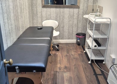 Tranquil treatment room at The Aesthetics Angel, London, England, GB, featuring a massage table and calming decor.