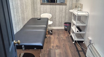 Tranquil treatment room at The Aesthetics Angel, London, England, GB, featuring a massage table and calming decor.