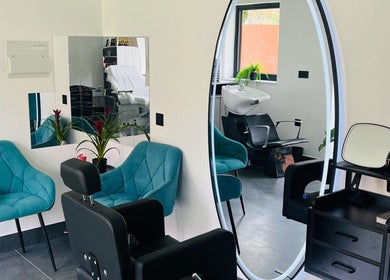 Stylish salon interior of Desantila's beauty in Barnet, England, GB with chic chairs and modern decor.