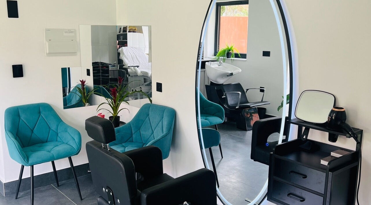 Stylish salon interior of Desantila's beauty in Barnet, England, GB with chic chairs and modern decor.