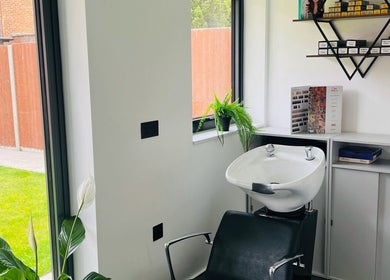 Bright wash station at Desantila's beauty in Barnet, England, GB, featuring sleek decor and lush greenery.