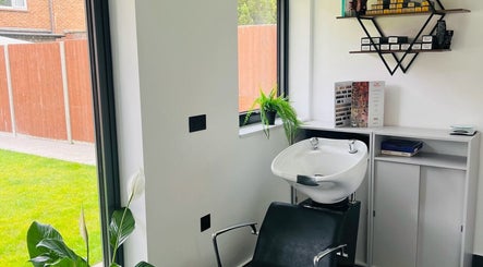 Bright wash station at Desantila's beauty in Barnet, England, GB, featuring sleek decor and lush greenery.