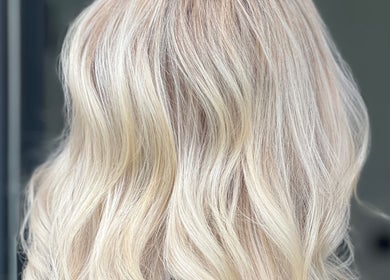 Blonde hair styled in soft waves at Desantila's Beauty, Barnet, England, GB.