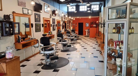 Barber shop interior at Forge & Foundry in Hastings, Hawke's Bay Region, NZ featuring classic black chairs.
