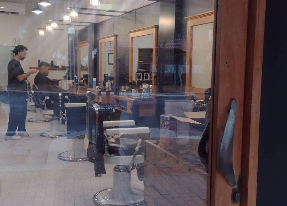 Inside view of Forge & Foundry salon in Hastings, Hawke's Bay Region, NZ, showcasing stylish hair stations.