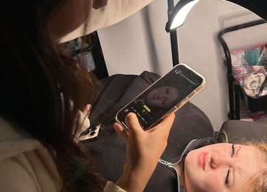 Client capturing beauty treatment results at KMRN.beauty, Cumbernauld, Scotland, GB, in a well-lit salon.