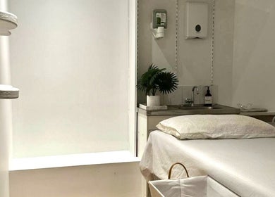 Tranquil treatment room at Arty Lash, Spring Hill, Queensland, AU, showcasing a plush bed and serene decor.