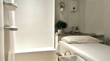 Tranquil treatment room at Arty Lash, Spring Hill, Queensland, AU, showcasing a plush bed and serene decor.
