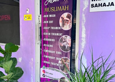 Dfyrifsaloon exterior with service banner in Langkawi, MY, highlighting hair and scalp treatments.