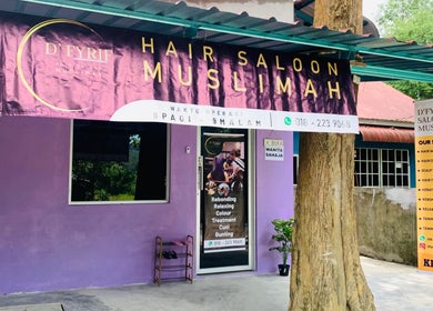 Exterior view of Dfyrifsaloon, a vibrant hair salon in Langkawi, MY with a prominently displayed services banner.