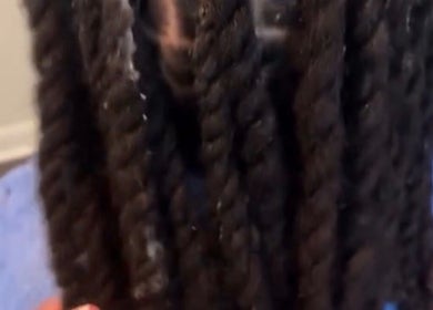 Close-up of intricate braids at Crownculturebraids_ in Killeen, Texas, US.
